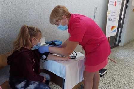 pielęgniarka dokonuje pomiaru ciśnienia uczennicy 