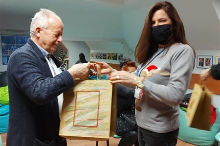 kobieta wręcza mężczyźnie papierową torbę